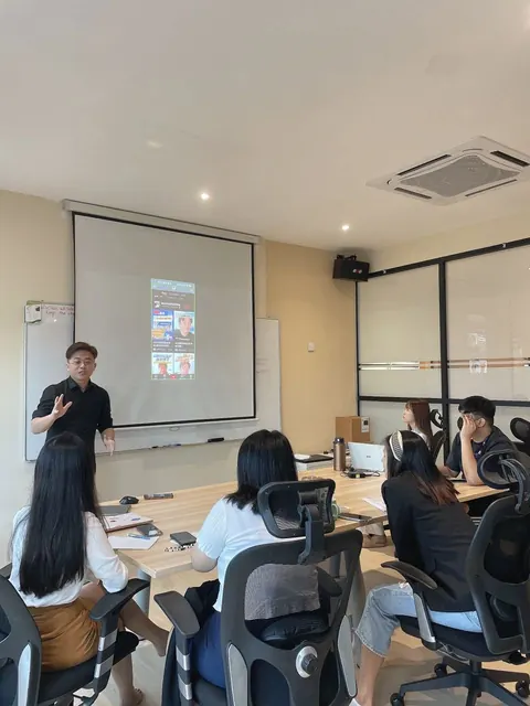 Trainer presenting to a small group in a corporate training room
