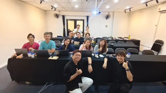 Participants with laptops at the end of a hands-on training session