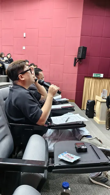 Trainer speaking to participants during a session